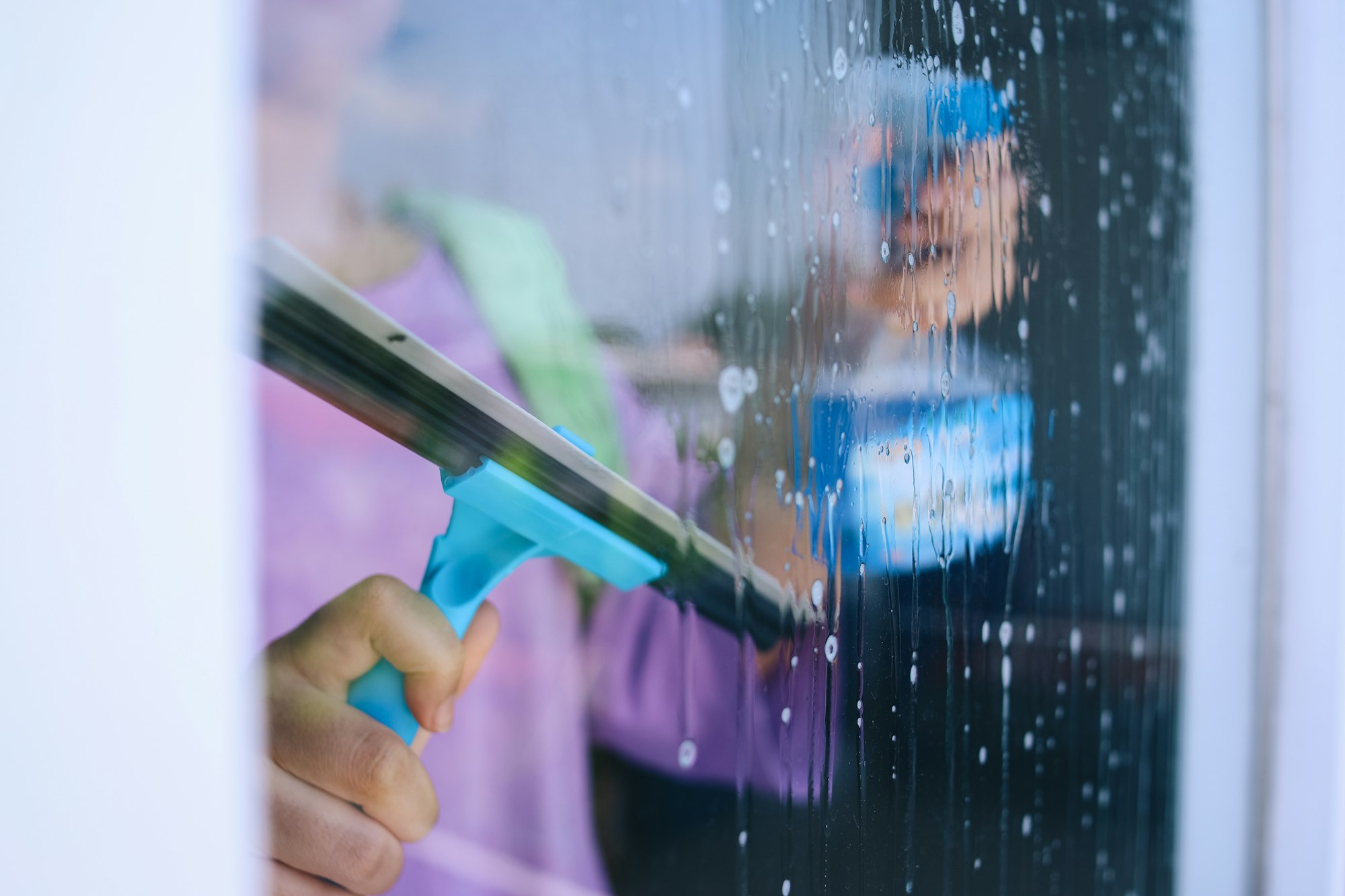 Woman Cleaning Window